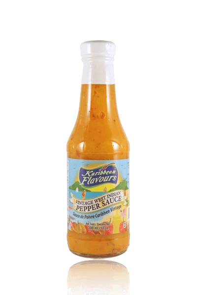 Karibbean Flavours Pepper Sauce 10oz bottle, perfect for spicing up dishes with Caribbean zest and heat.